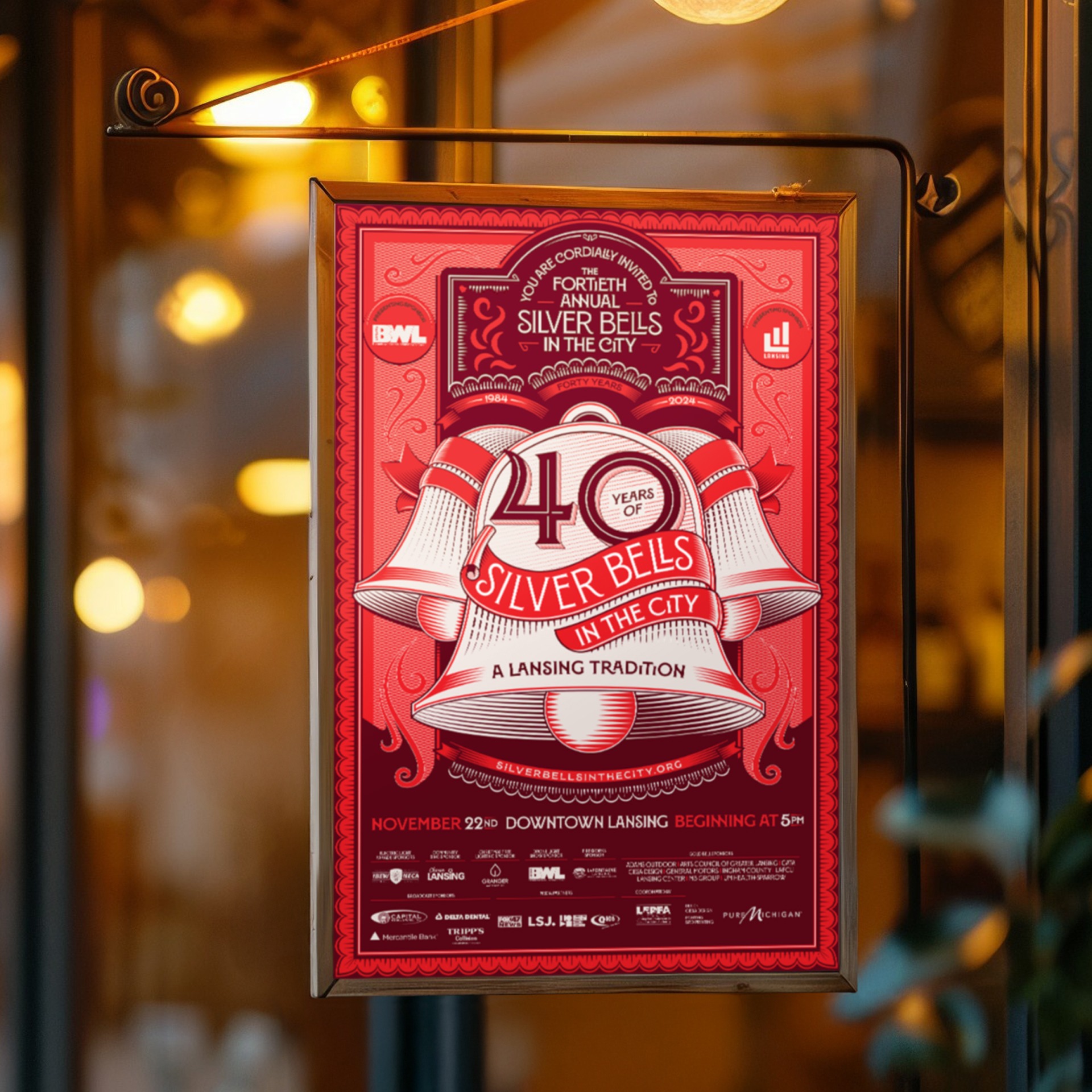 Silver Bells in the City 2023 poster hanging on a glass window.